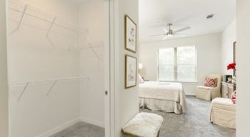 Oversized closet at entry to model bedroom with carpet flooring at The Retreat at Fairhope Village in Fairhope, AL